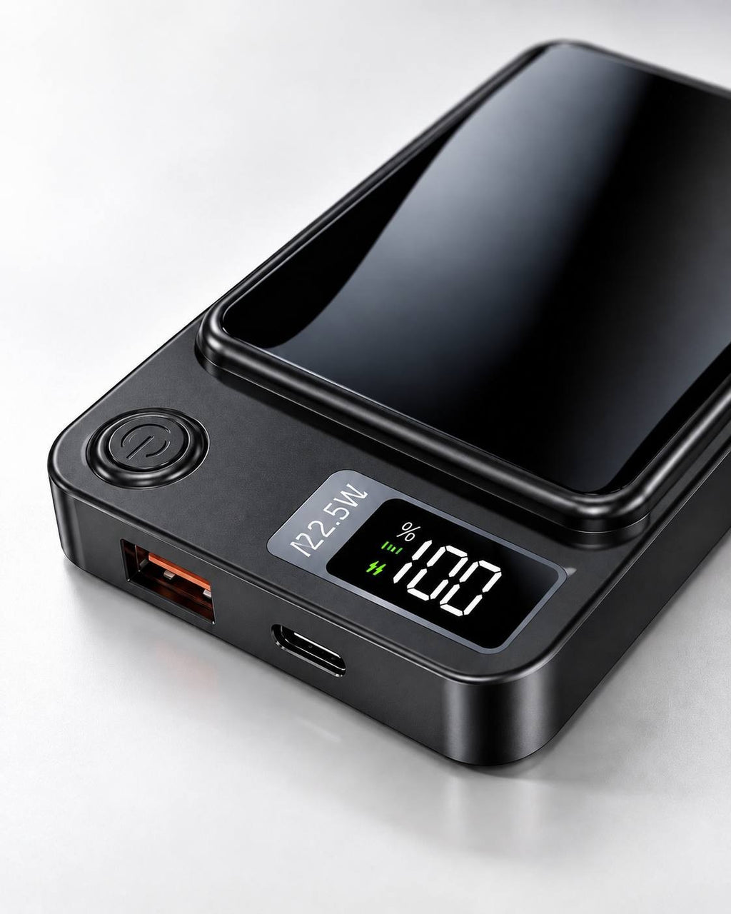 Studio product photo of a black 22.5W fast charging power bank featuring a digital percentage display, power button, USB port, and Type-C port on a reflective surface.