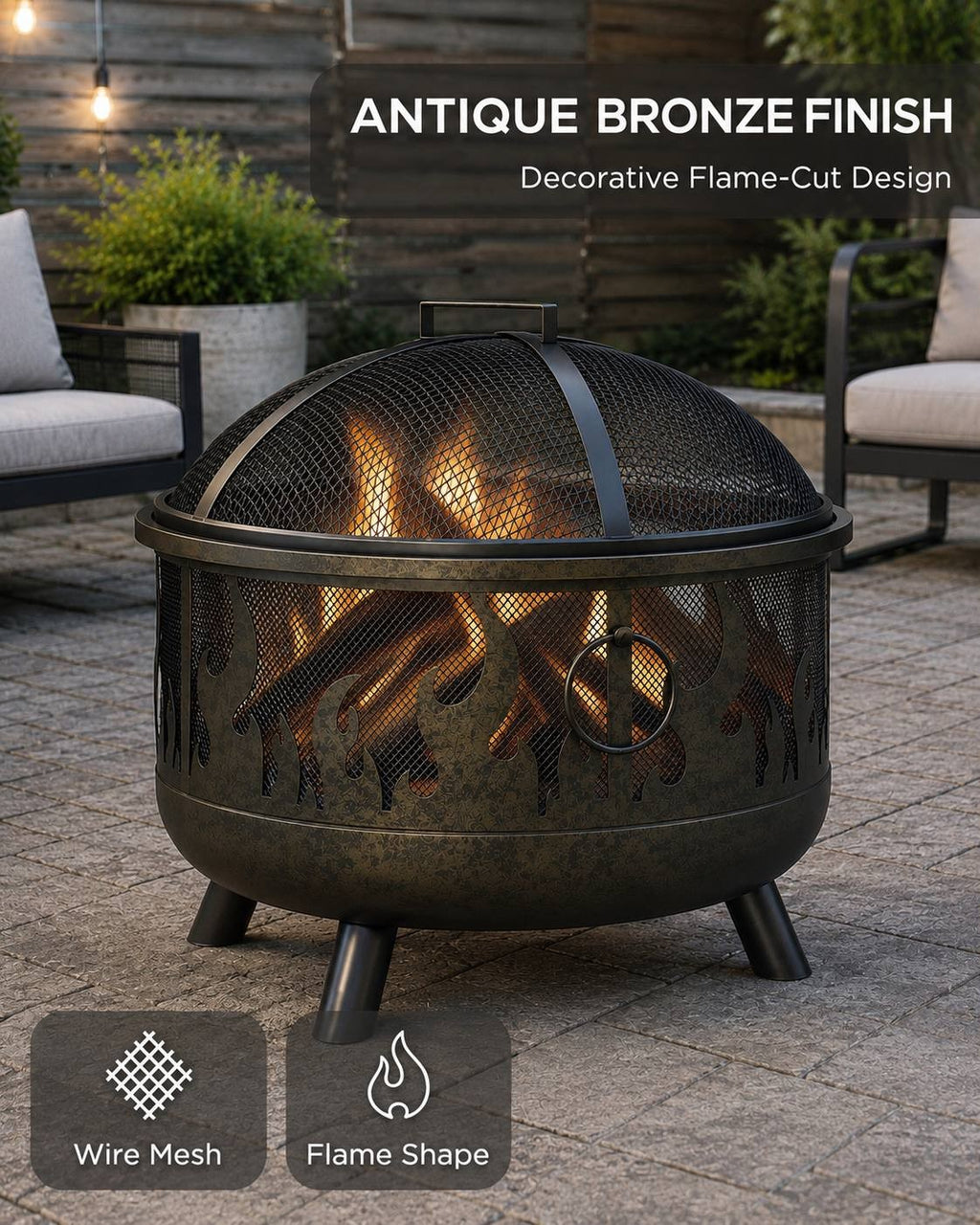 Black and antique bronze finish metal fire pit with a wire mesh spark screen and a decorative flame-cut pattern around the bowl, standing on a patio.
