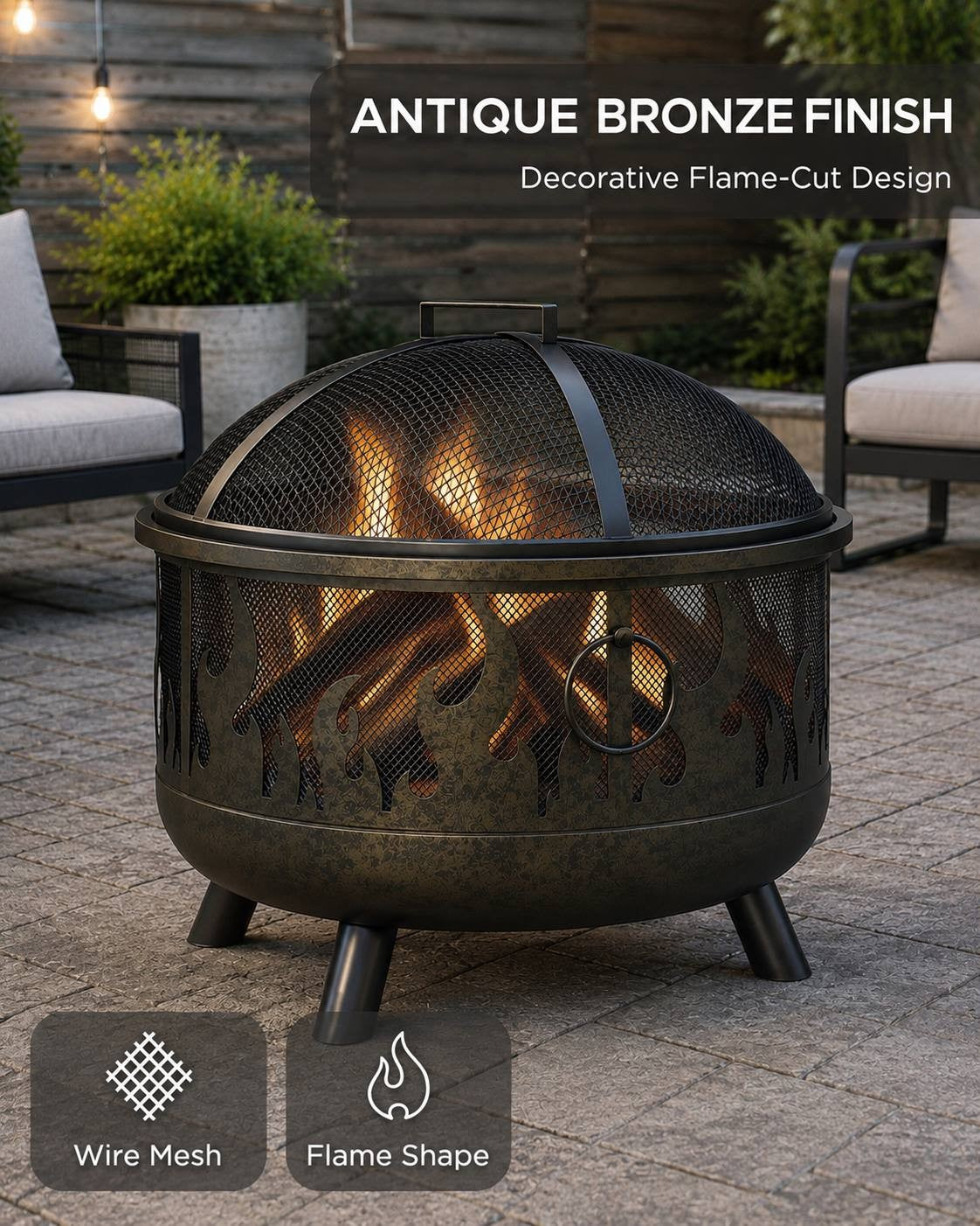 Black and antique bronze finish metal fire pit with a wire mesh spark screen and a decorative flame-cut pattern around the bowl, standing on a patio.