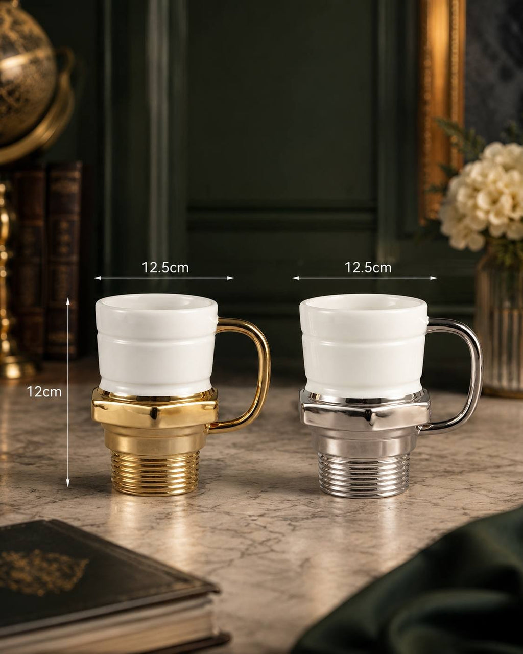 An elegant setting featuring a gold and a silver glow plug coffee mug, each measuring approximately 12cm in height and 12.5cm in width, placed on a marble surface with an antique globe and dark wood paneling.