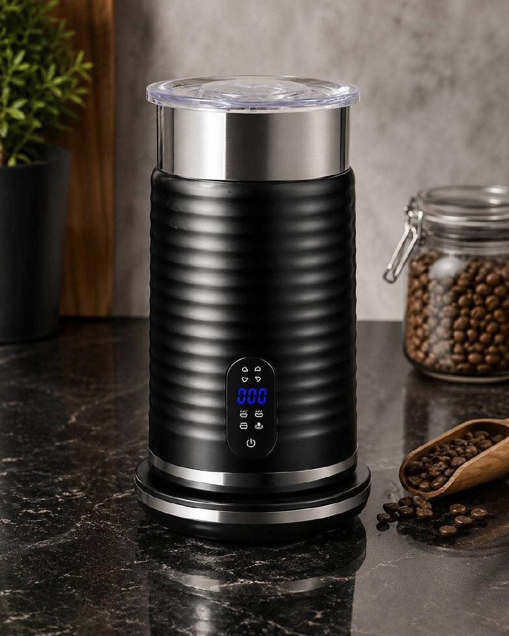 Sleek black electric milk frother standing on a clean kitchen countertop.