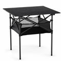 A studio product shot of a square black folding camping table with slatted top and an integrated lower mesh storage bag against a clean white background.