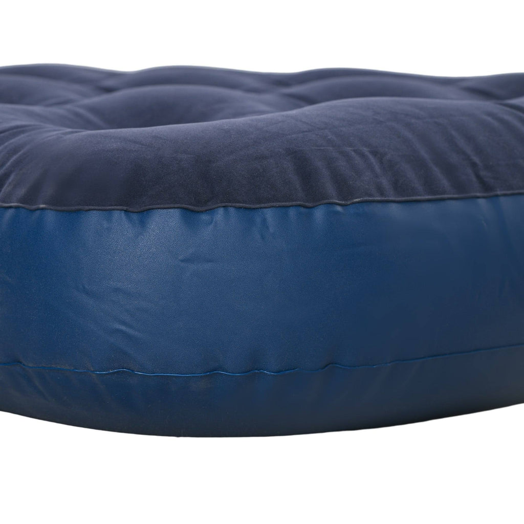 Close-up view of the dark blue flocked top surface and smooth vinyl sidewall of an inflatable air mattress isolated on a white background.