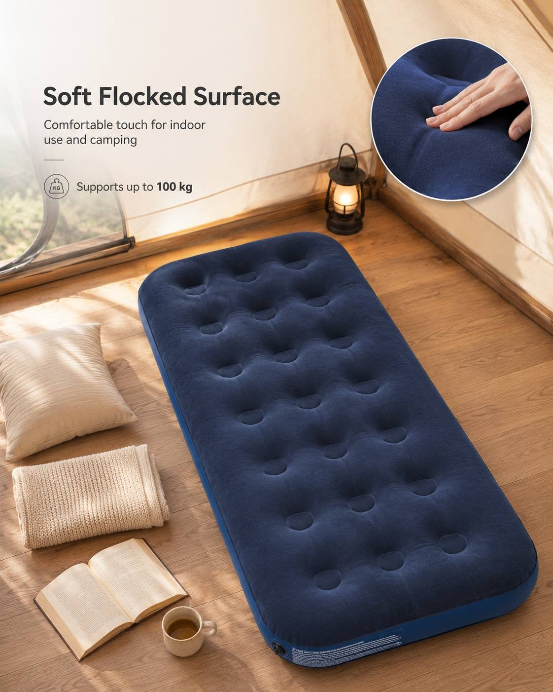 Infographic highlighting the soft flocked surface and 100 kg weight capacity of a single blue air mattress set up inside a tent.