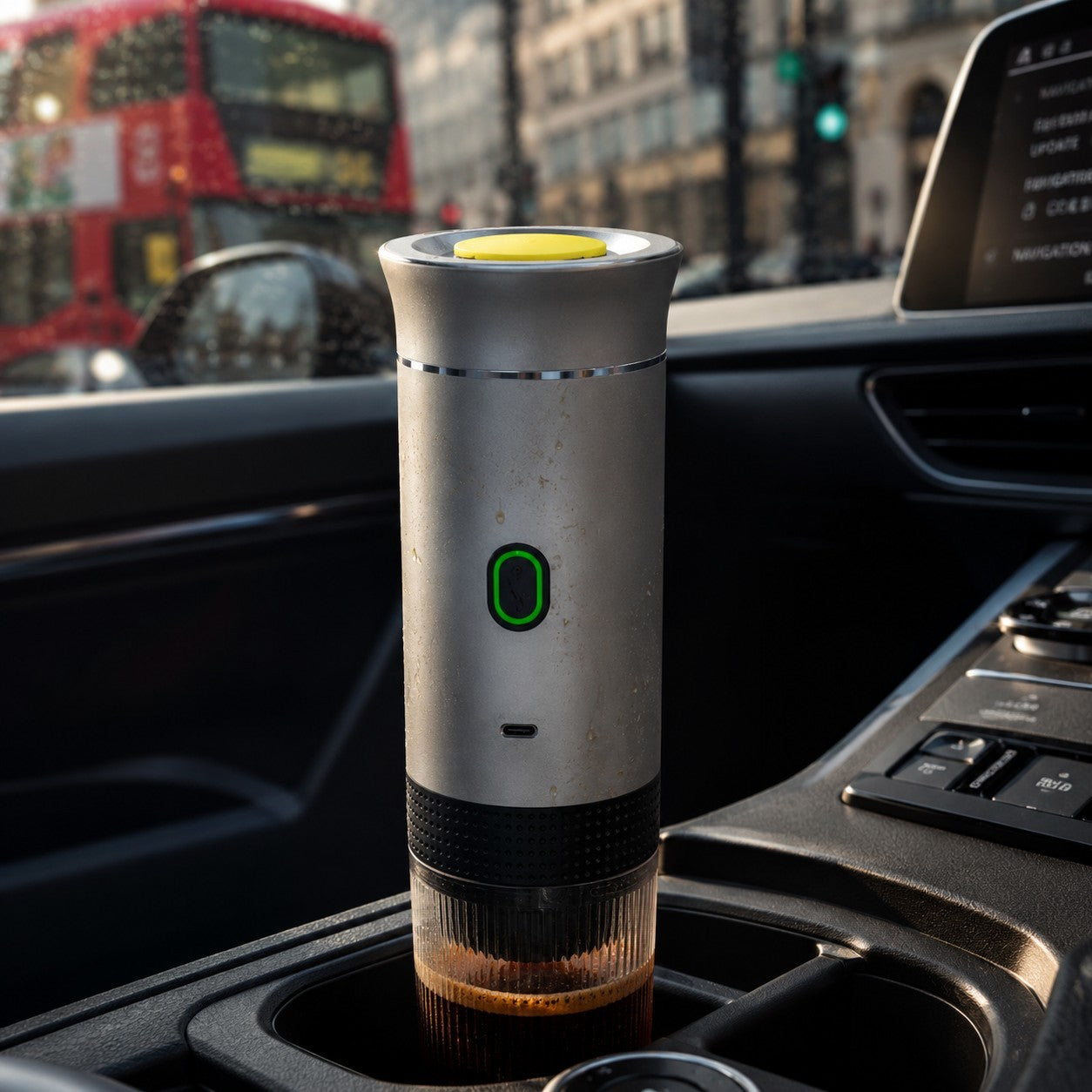 Portable coffee maker in a car cup holder with a cityscape background