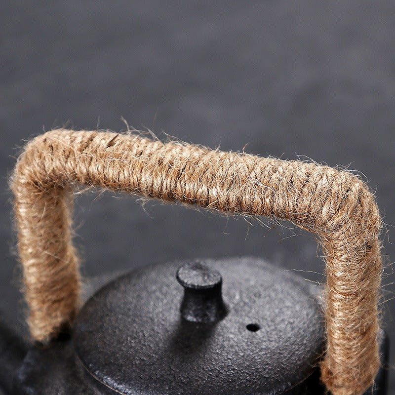 Black metal lid with a woven handle on a dark background