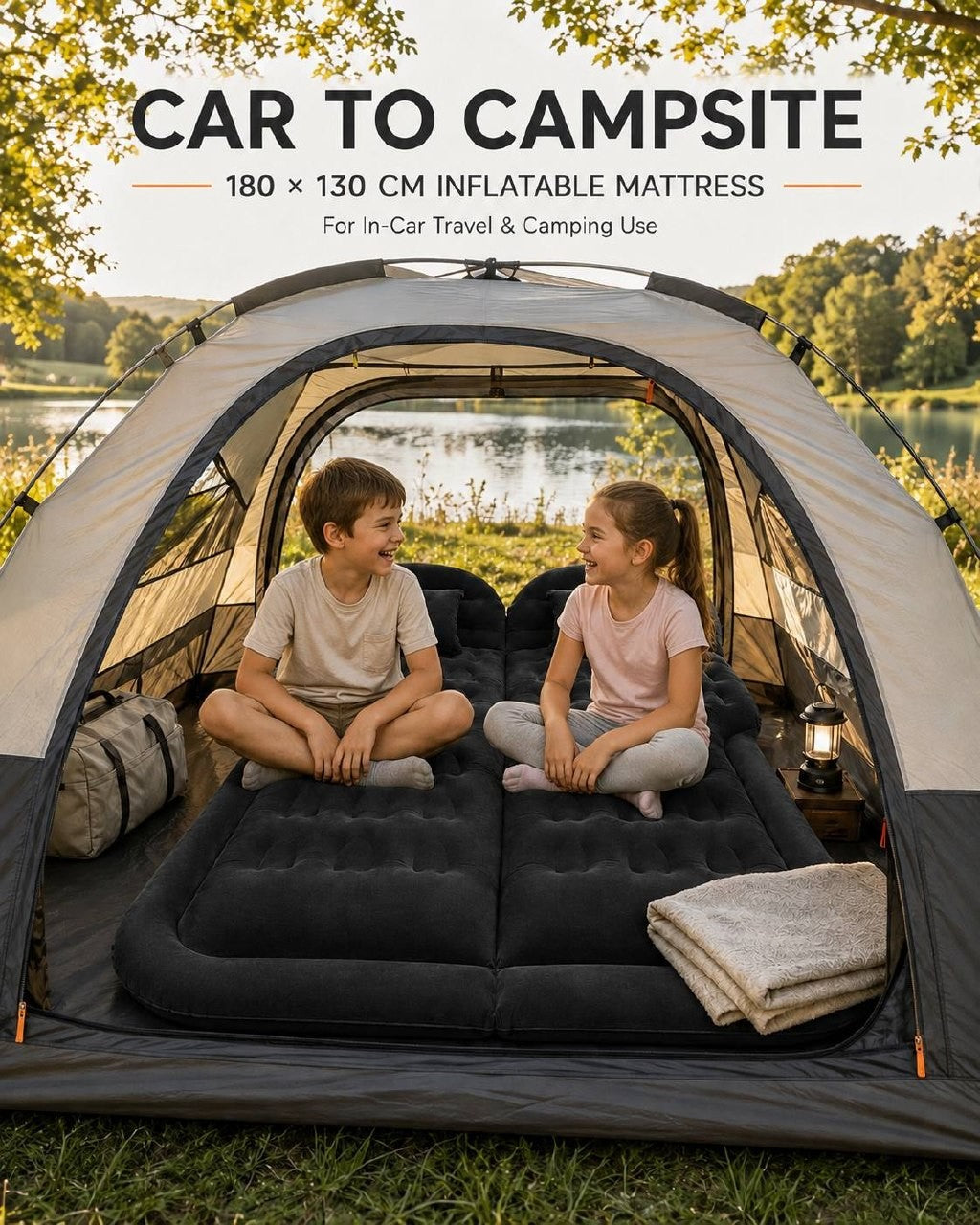 A young boy and girl sitting and laughing together on a black inflatable mattress inside a camping tent overlooking a lake.