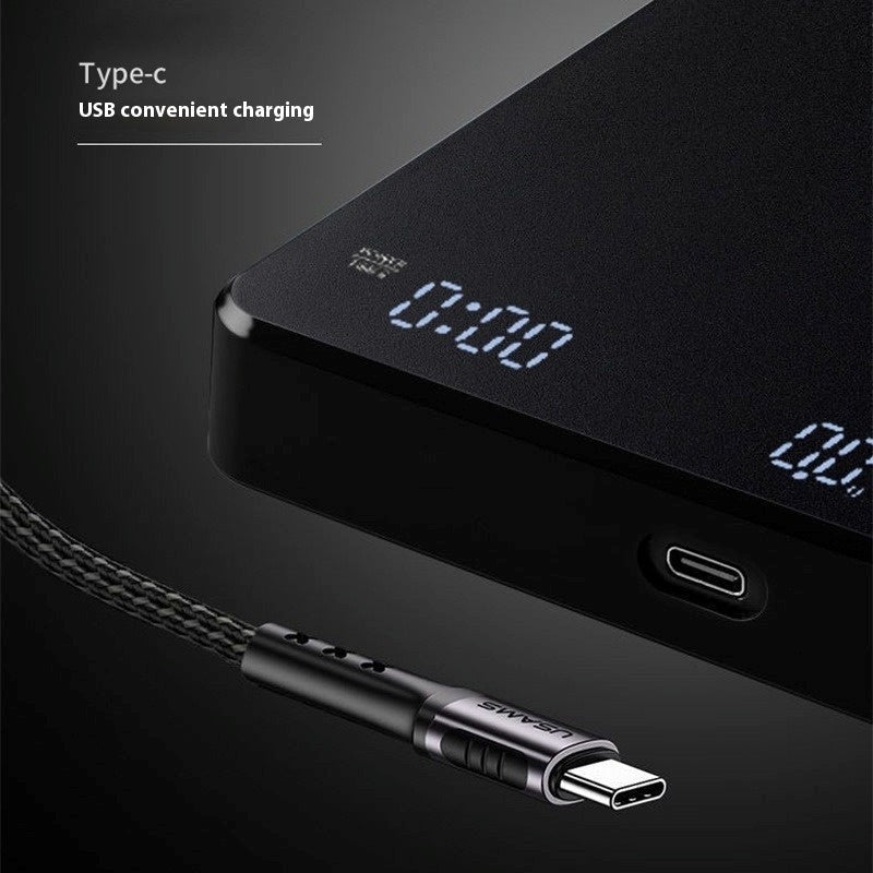 Black electronic device with digital display and USB cable on a dark background