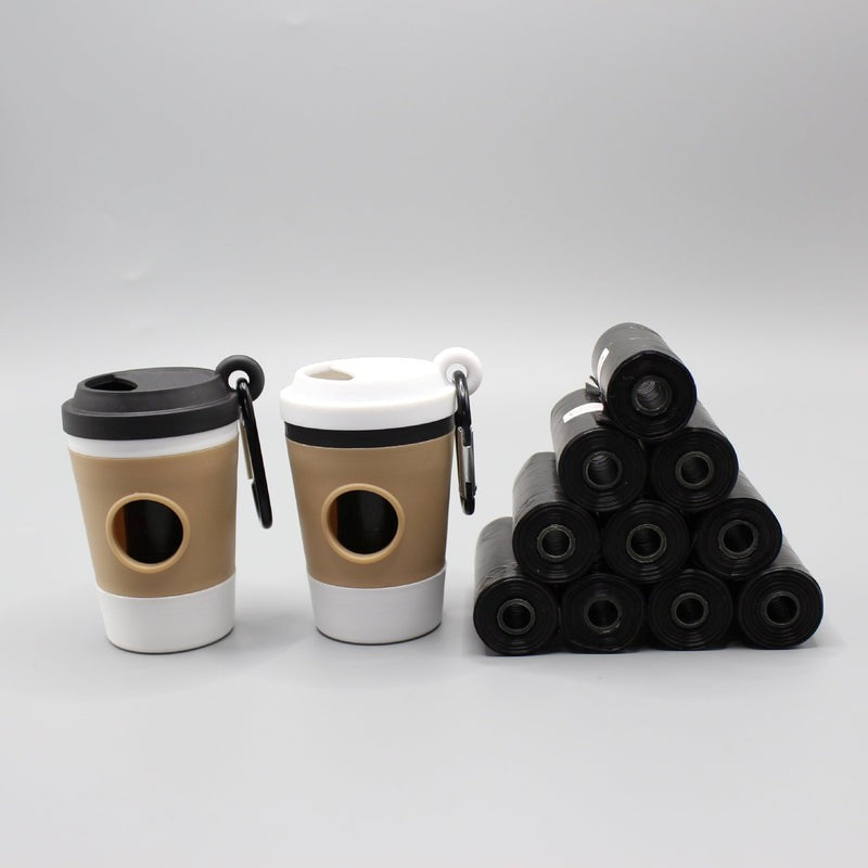 Two coffee cup-shaped containers with black lids and a pyramid of black cylindrical objects on a gray background.