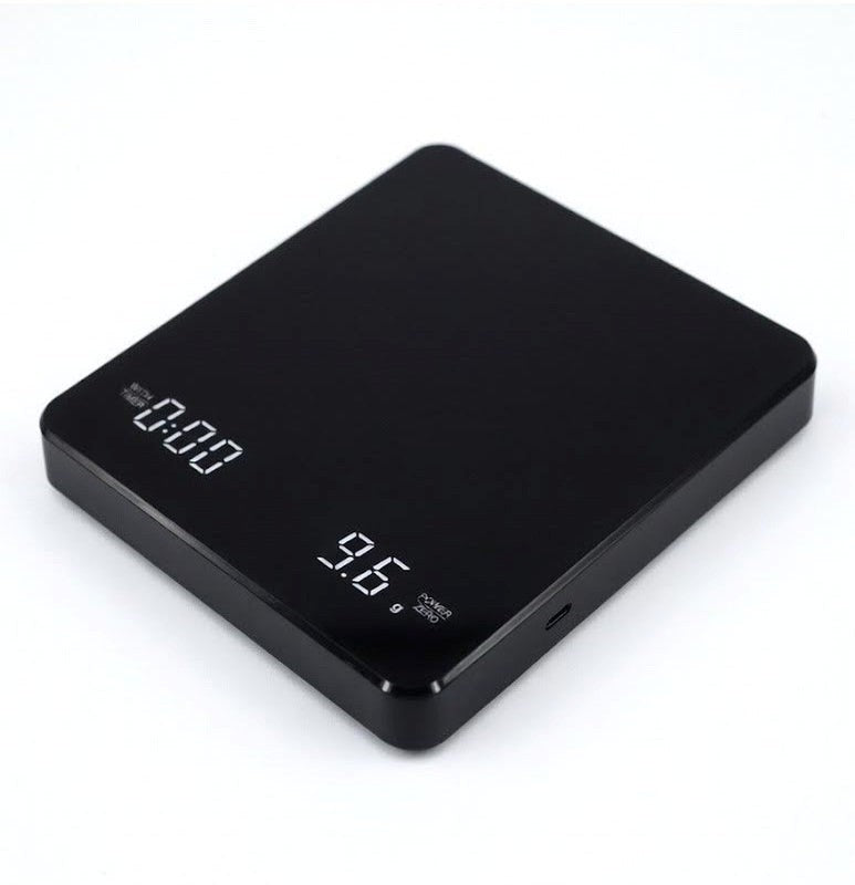 Black digital kitchen scale on a white background