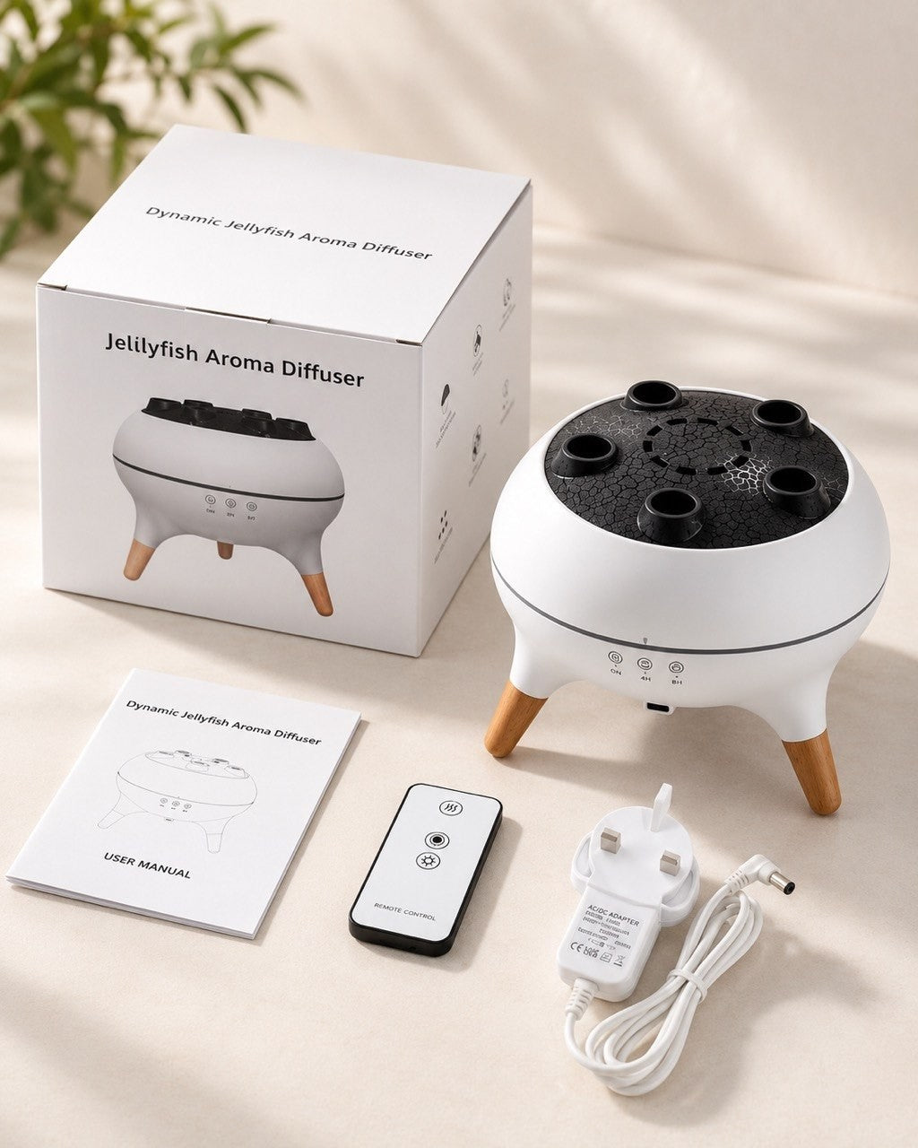 Unboxing view showing the Dynamic Jellyfish Aroma Diffuser box, user manual, remote control, and UK-type AC/DC power adapter.