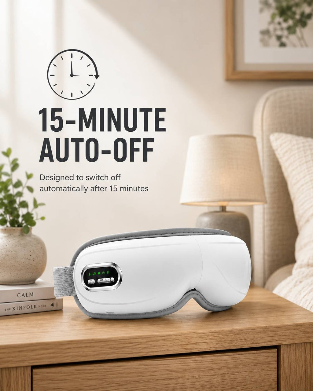 A white electric airbag eye massager placed on a wooden bedside table next to a lamp and books, featuring a 15-minute auto-off function.