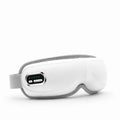 Studio product shot of a white electric airbag eye massager with a digital control panel and gray elastic headband against a clean white background.