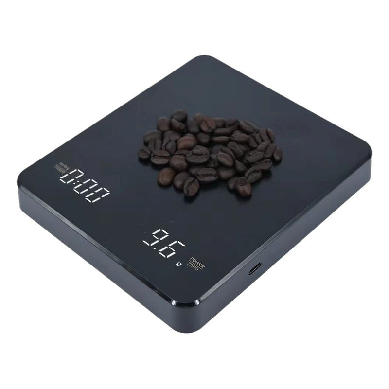 Digital kitchen scale with coffee beans on a white background