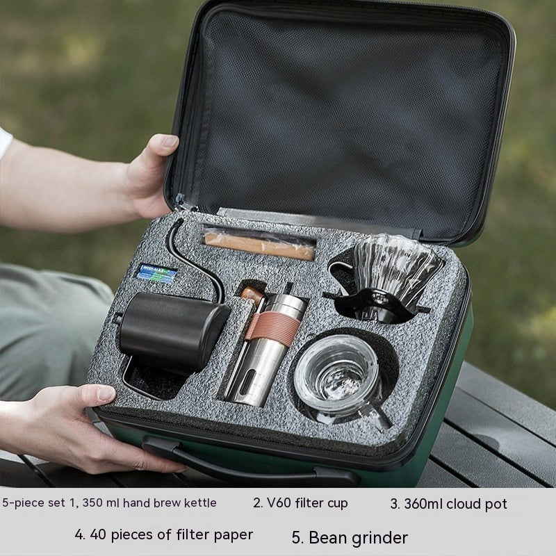 Portable coffee brewing kit with various components in a carrying case.