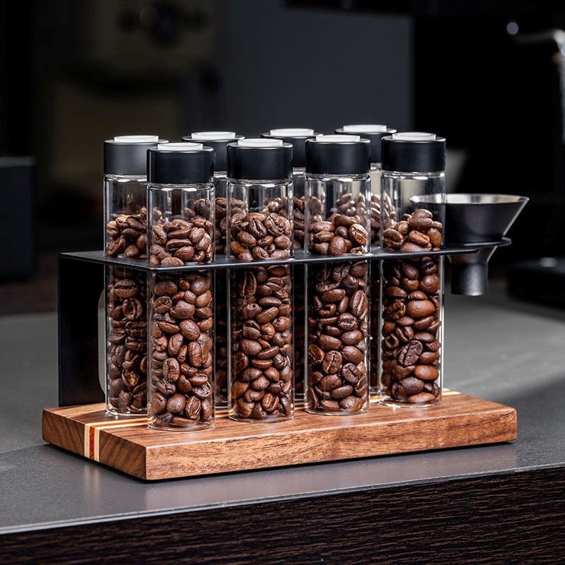 Glass jars with coffee beans on a wooden stand in a kitchen setting