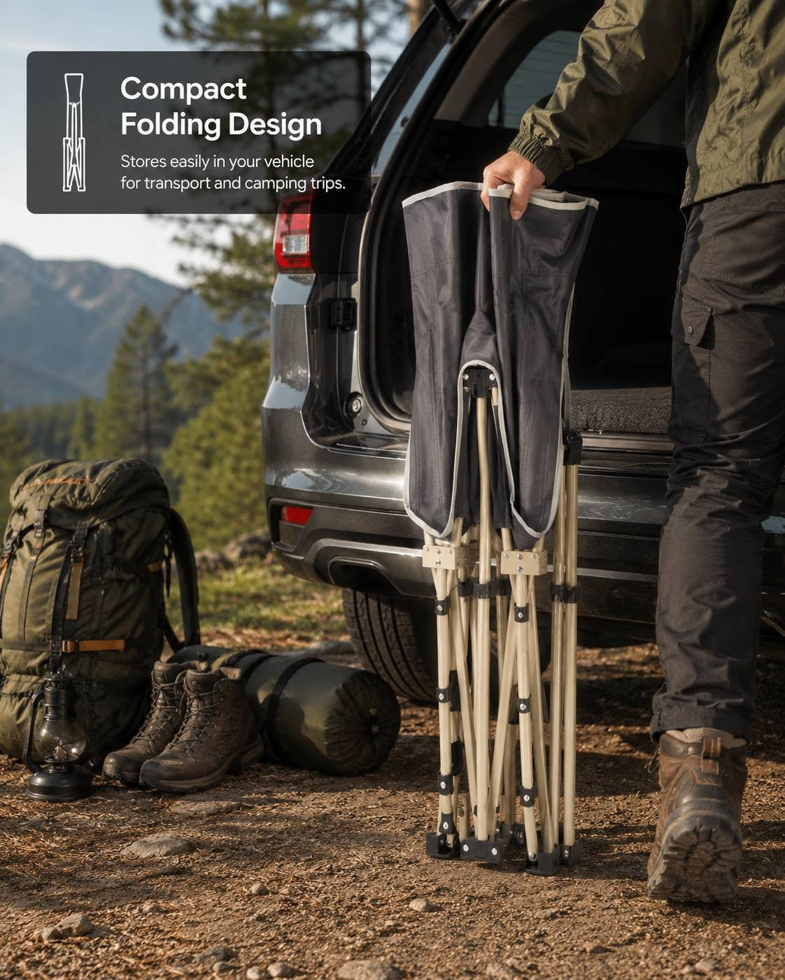 Person holding a compact folded grey camping cot next to the trunk of an SUV parked in a forest campsite.