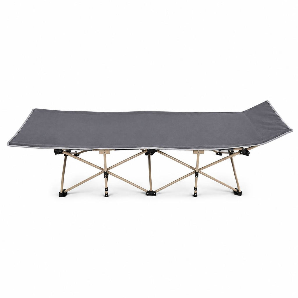 Side view of a grey folding camping cot with an elevated headrest isolated on a white background.