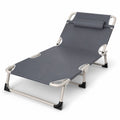 A grey folding sun lounger with a matching headrest pillow and sturdy metal frame, presented isolated on a clean white background.