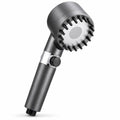 Studio product photo of a grey handheld shower head with silicone massage bristles and a pause/stop button against a clean white background.