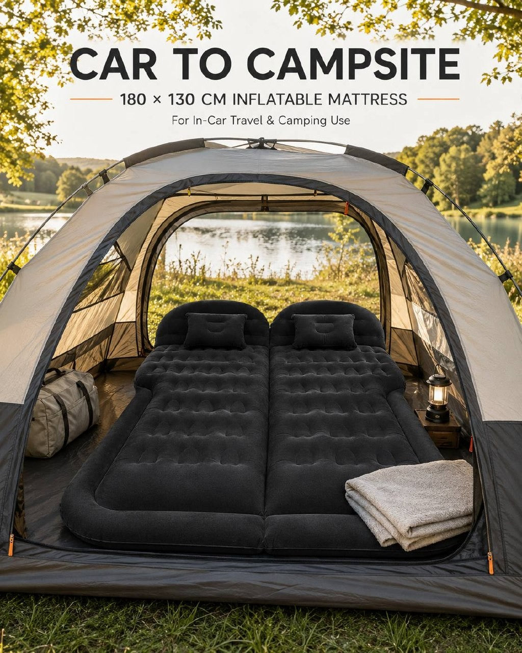 Black inflatable camping mattress set up inside a spacious tent with a scenic lake and forest view in the background.