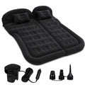 Black inflatable car mattress with two matching pillows, an electric air pump, a power cord, and three nozzle adapters, isolated on a white background.