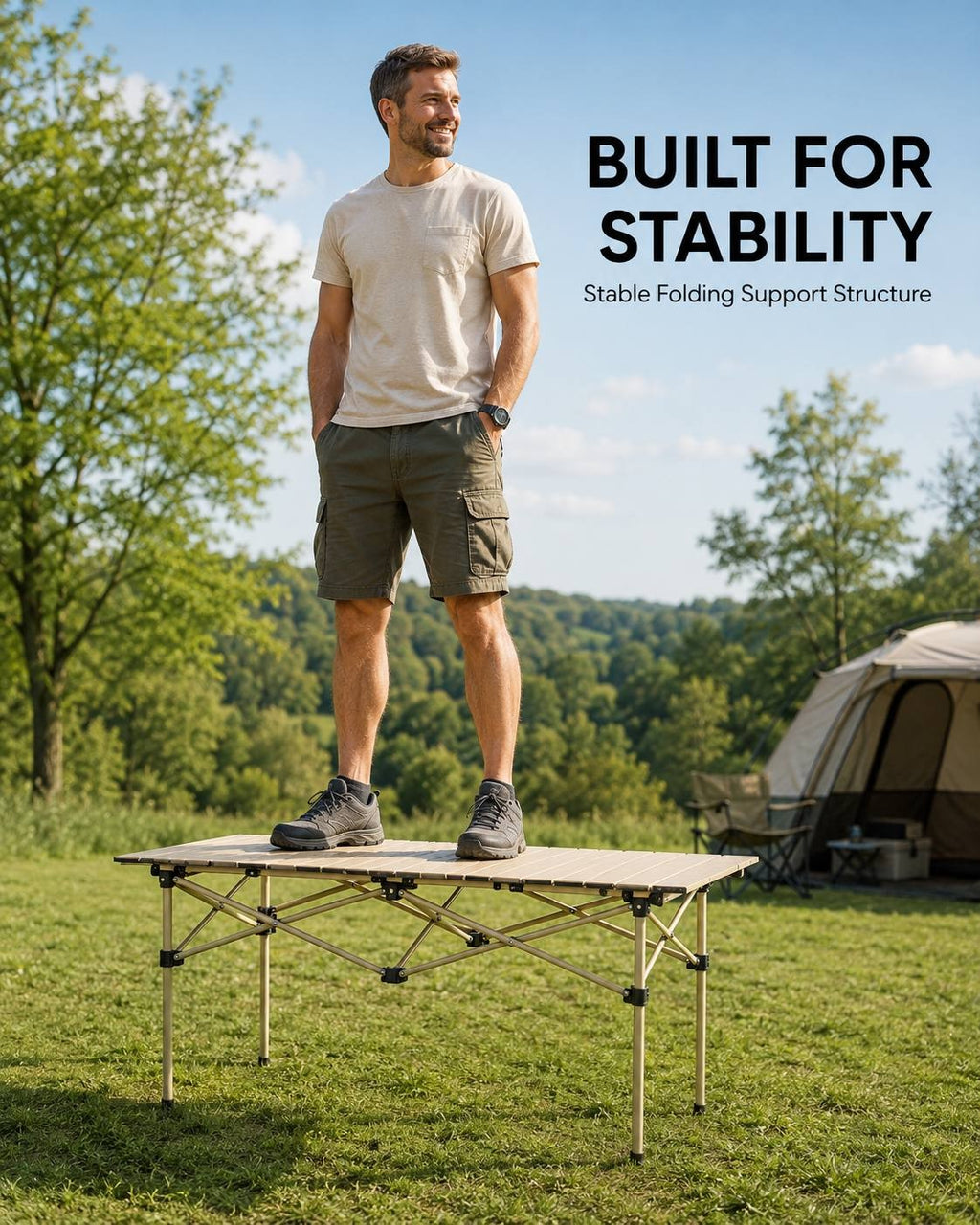 A man standing on top of a sturdy folding camping table outdoors to demonstrate its weight capacity and stability structure.
