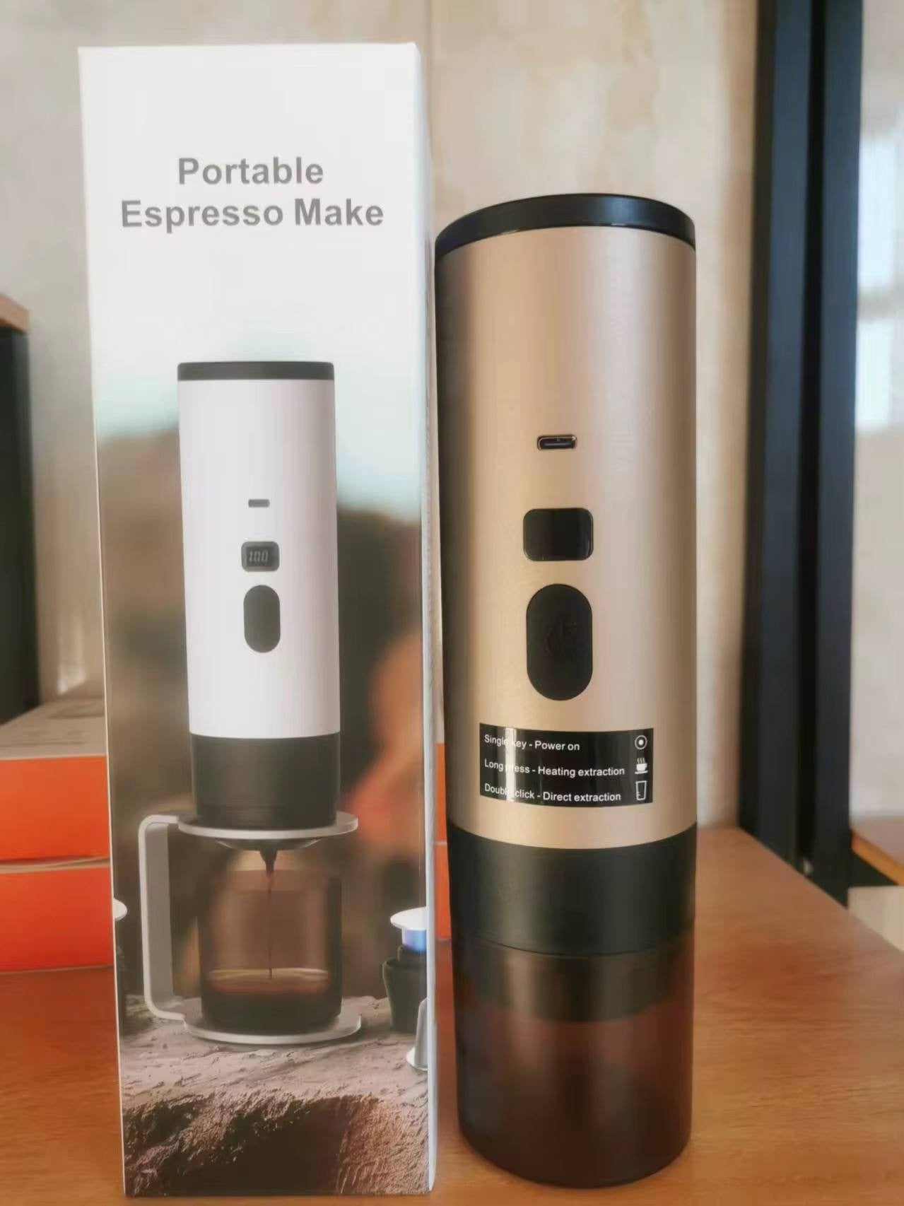 gold travel espresso machine showcasing its retail product box and sleek metallic handheld design