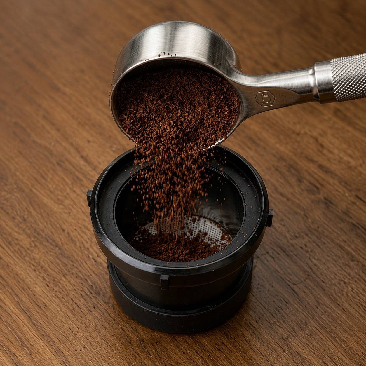 Portable espresso maker being filled with ground coffee