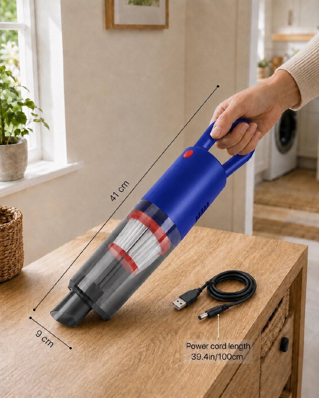 An informational image showing the dimensions of a blue portable handheld vacuum cleaner, measuring 41 cm in length and 9 cm in width, displayed alongside a USB power cord with a length of 39.4 in / 100 cm on a wooden table.