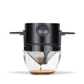 Black coffee maker with glass carafe on a white background