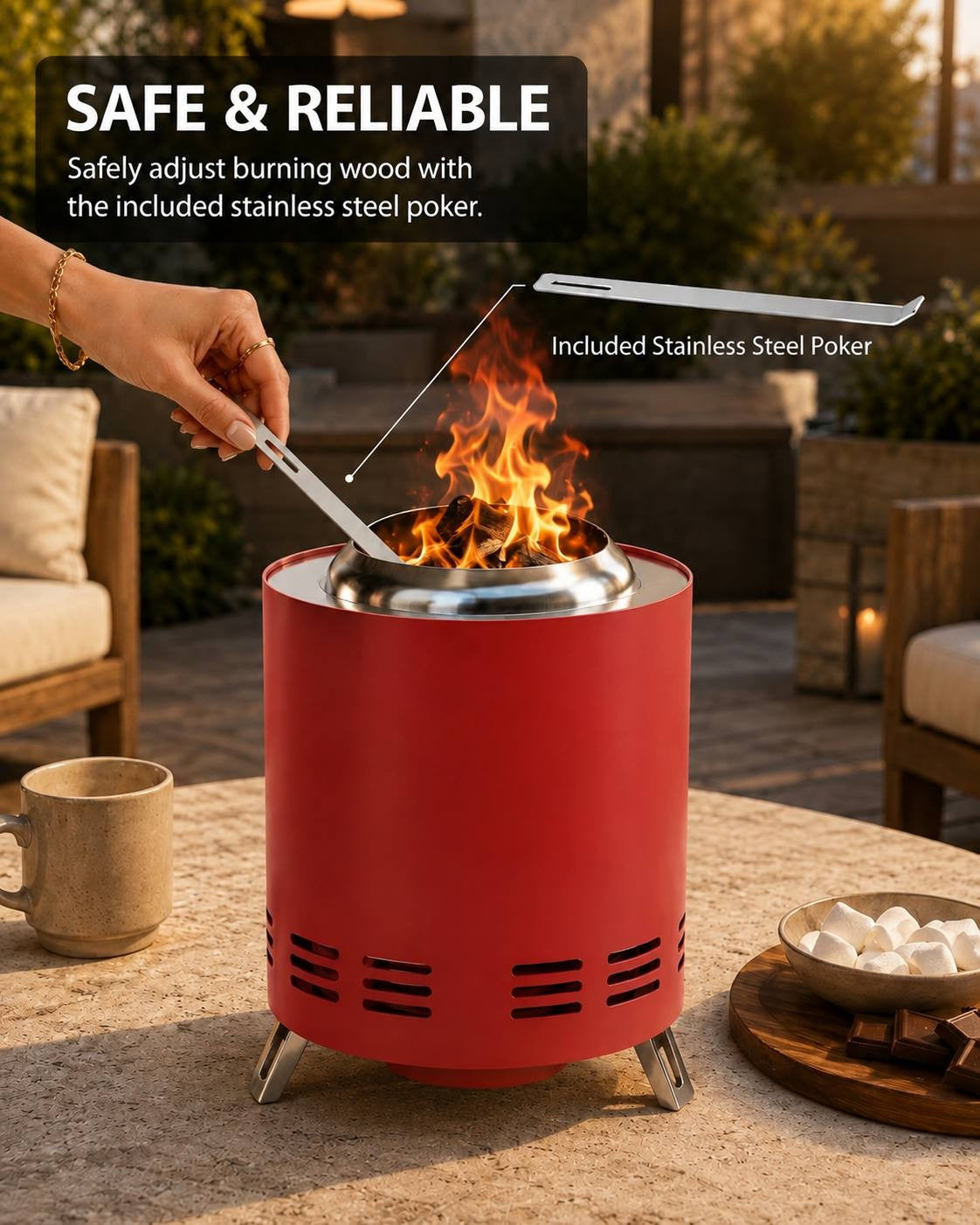 A red cylindrical portable fire pit with a stainless steel poker being used to adjust burning wood, shown on an outdoor patio. Text on the image highlights the safety and included stainless steel poker.
