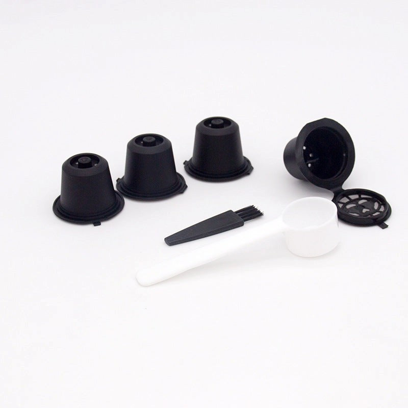Set of black plastic components and a white spoon on a white background