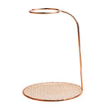 Copper-colored metal mesh stand on a white background