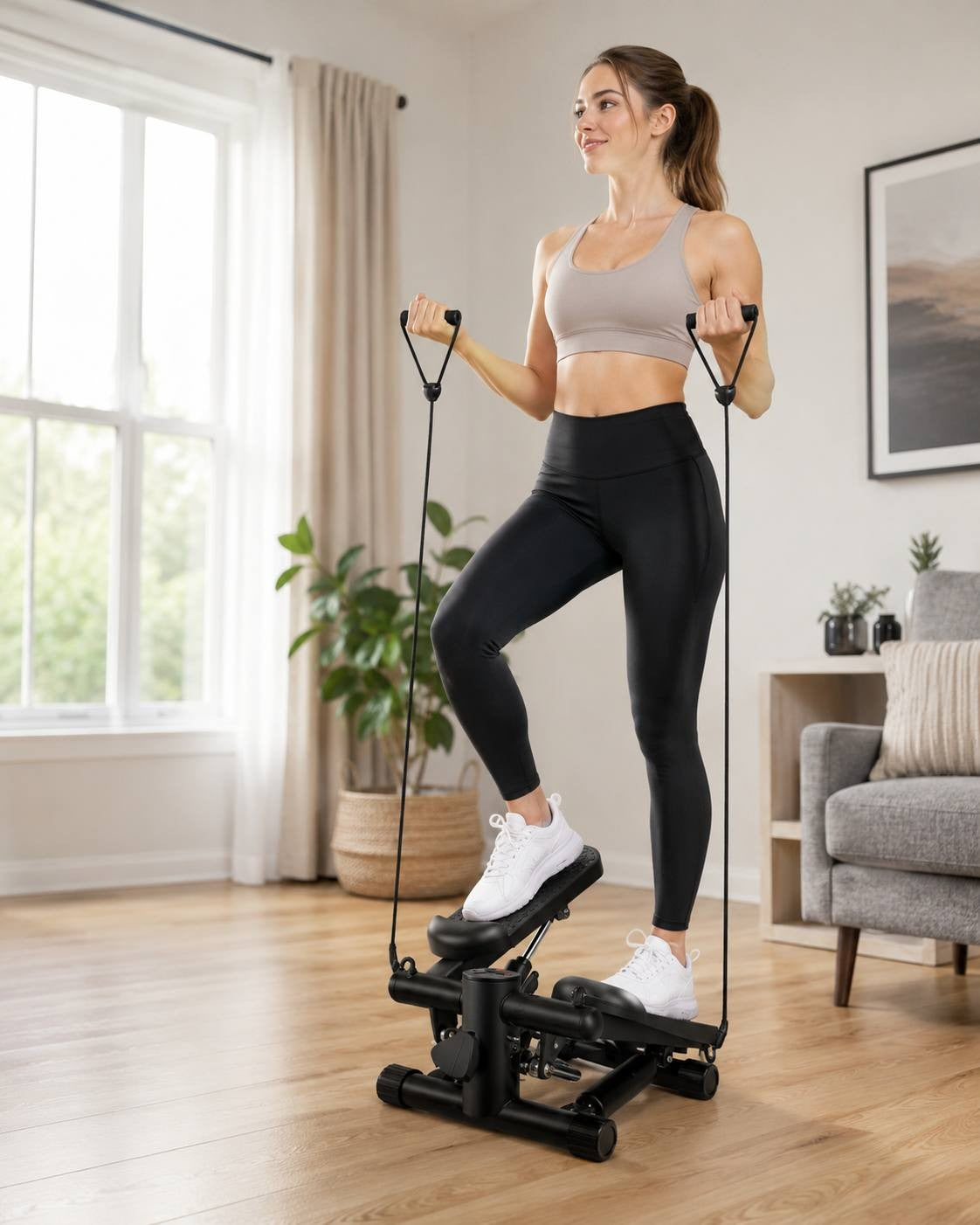 A woman in an activewear set standing on a black exercise stepper with resistance bands in a bright living room, performing a stepping workout near a window.